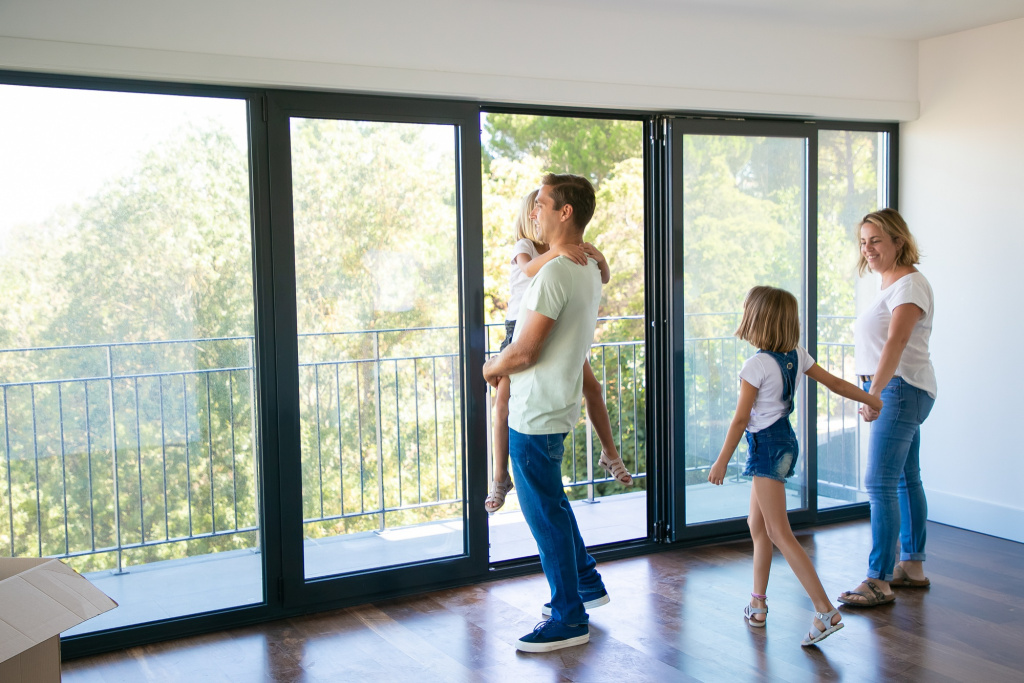 happy-father-with-daughter-standing-near-open-balcony-smiling.jpg