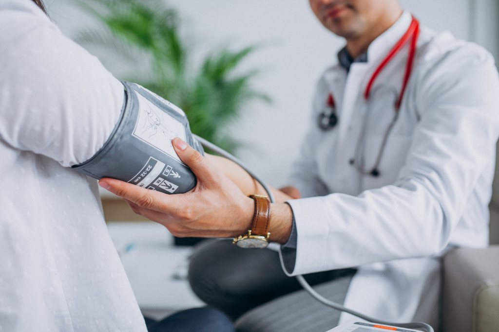 young-male-psysician-with-patient-measuring-blood-pressure.jpg