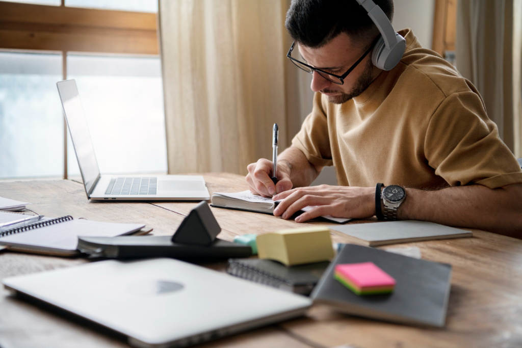 young-man-writing-notebook-during-study-session.jpg